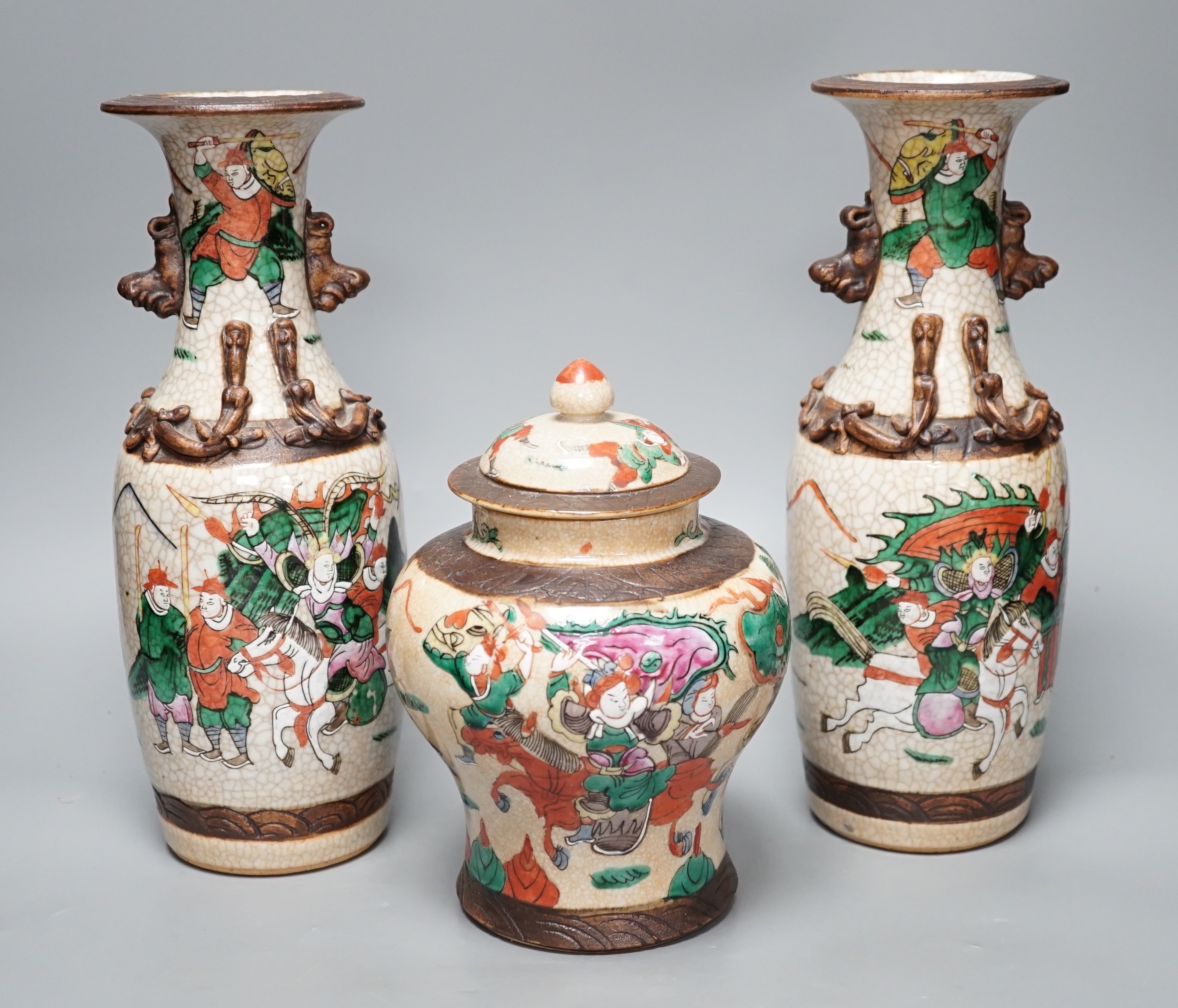 A pair of late 19th century Chinese crackle glaze vases and a similar vase and cover, tallest 29.5cm